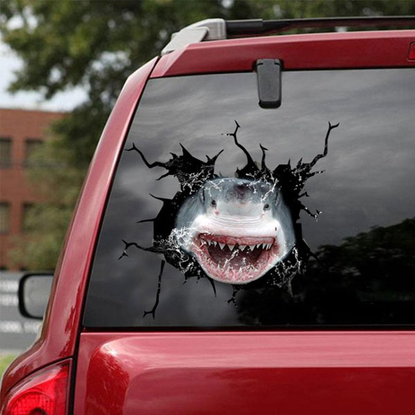Photo of a decal showing a shark breaking out of the back window of a car