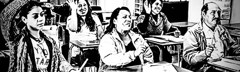 Black and white photo: adult Latino students in a classroom