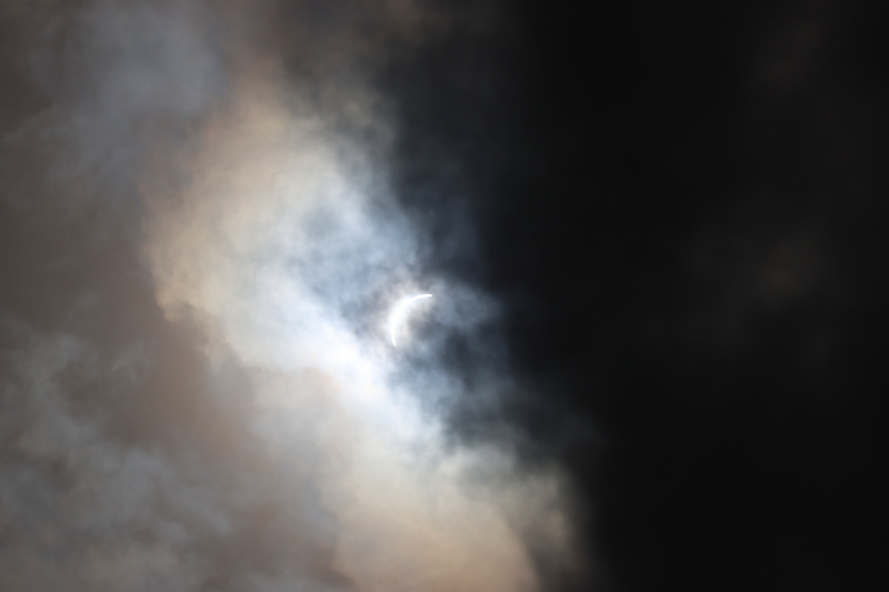 Photo: Eclipse nearing totality, partially obscured by clouds