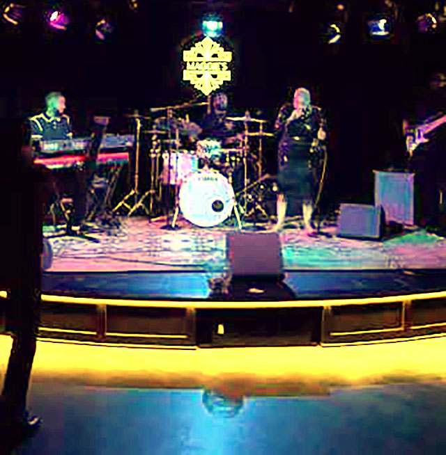 Photo: Bandstand and dance floor at Maggie's speakeasy