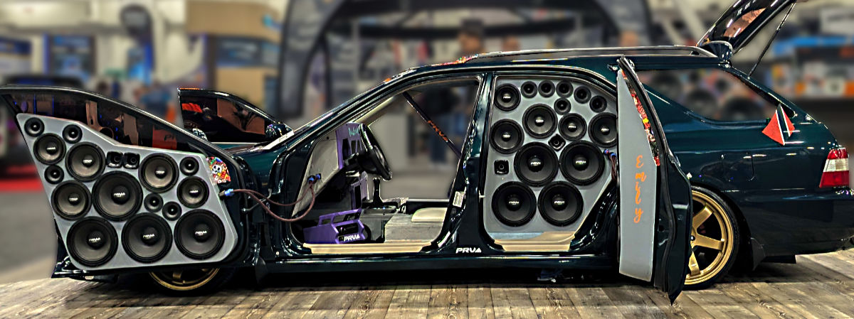 Photo: A heaviliy customized car at SEMA 2025 with speakers covering almost every square inch of interior