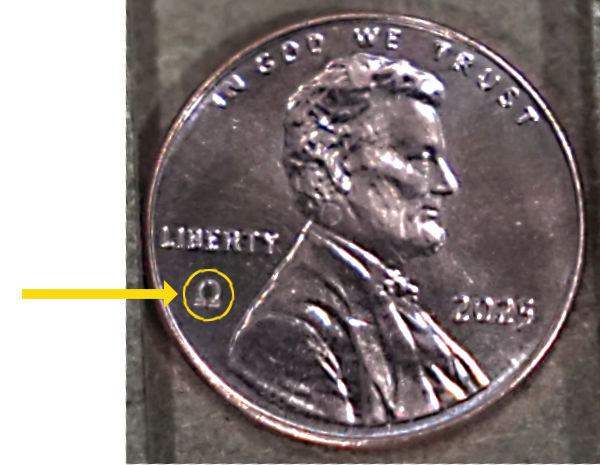 US penny with the Omega symbol, signifying it as one of the last pennies to be minted