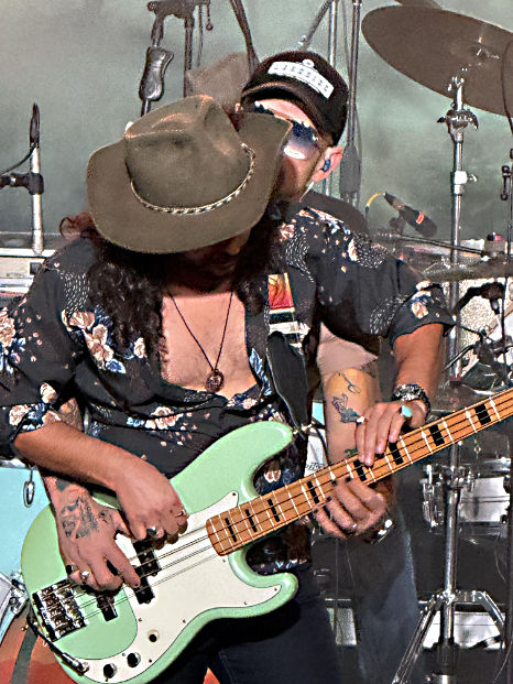 Photo: Sean Rodriguez and Andy Rogers jointly play Sean's electric bass during a concert in San Antonio, TX in December, 2025