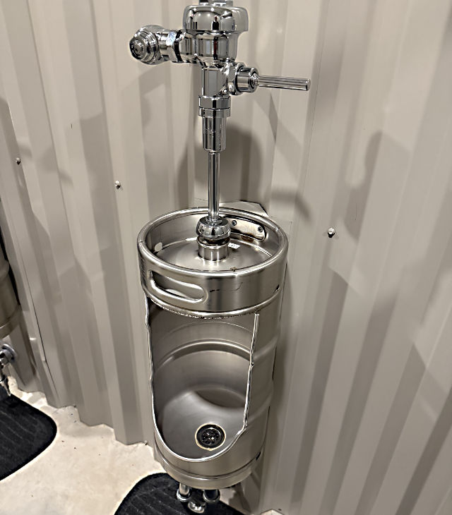 Photo: A urinal made from a polished silver beer keg